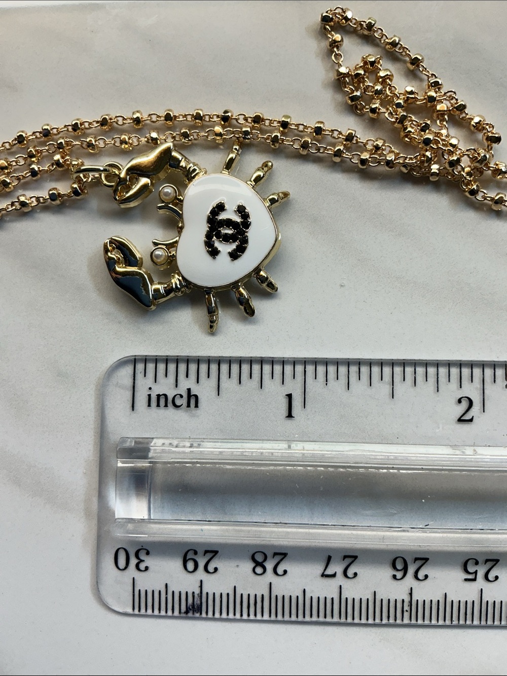 Gold-Tone Crab Pendant Necklace with White Enamel Heart and Black Logo - Picture 6 of 7
